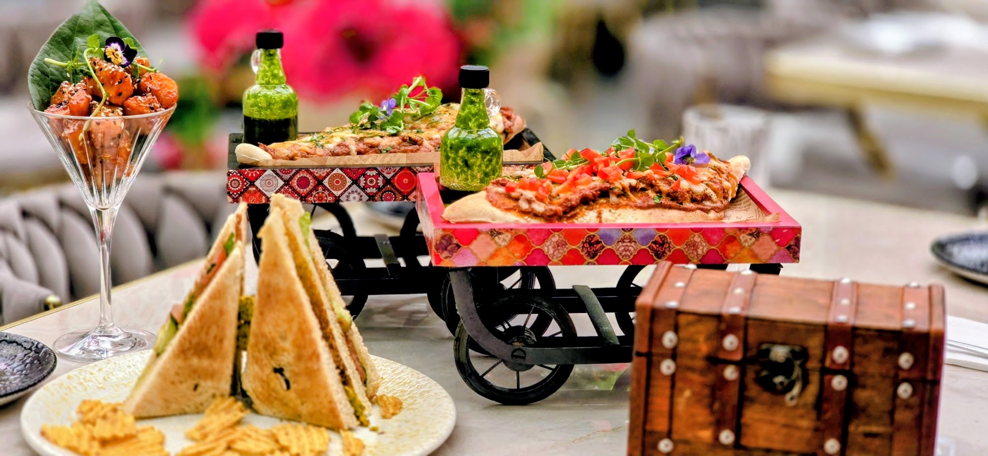 Sandwiches, canapés and sauces displayed on decorative miniature serving carts